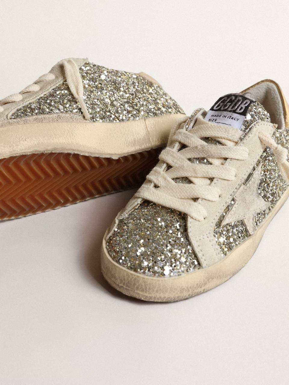Super-Star Young in glitter with a suede star and gold heel tab